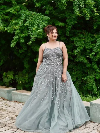 The full view of this grey-blue gown shows its graceful flow and flattering A-line shape.