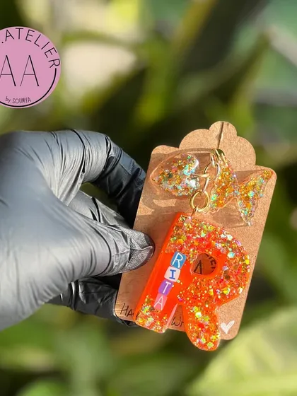 Another angle of the personalized 'Rita' keychain, showing the letter 'R' and the name spelled out in beads. These are perfect for bulk orders for party favors or friend groups.