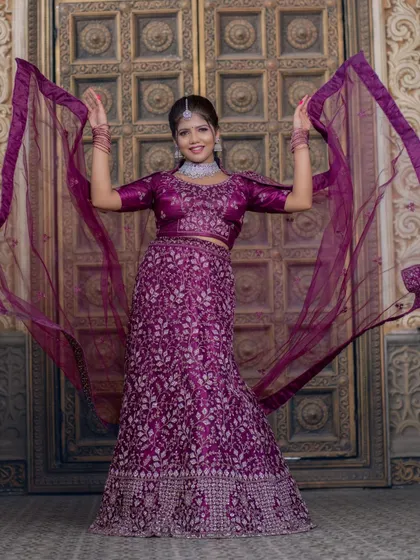 A playful shot with the dupatta, showing the movement and flow of the outfit. The makeup stays perfect even with movement.