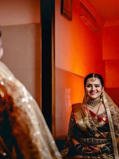A mirror shot of the bride, capturing her happy reflection on her wedding day.
