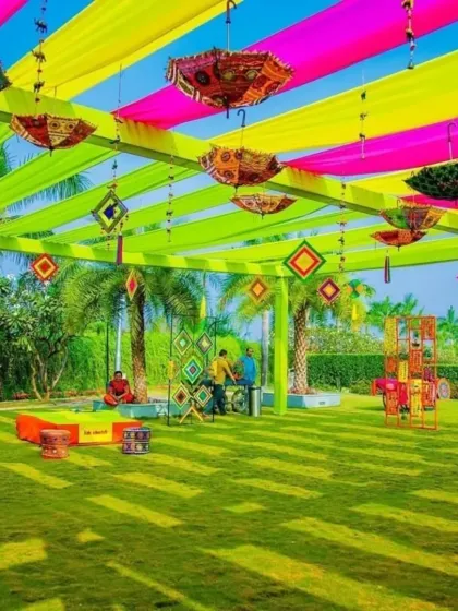 A wide view of a Mehendi setup on a lawn, showing the vibrant canopy with hanging umbrellas and ample space for guests to mingle and celebrate.