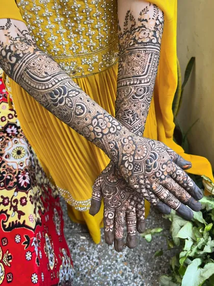 A detailed shot of bride Aain's mehndi, with her yellow outfit providing a beautiful contrast.