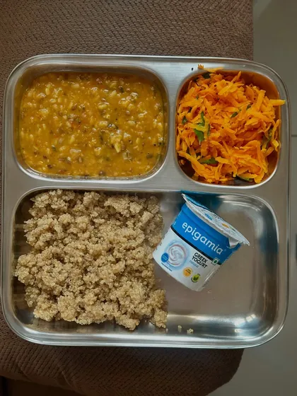 A vegetarian meal of quinoa, barley dal, carrot salad, and Greek yogurt. This is a great example of a high-fiber, protein-rich lunch.