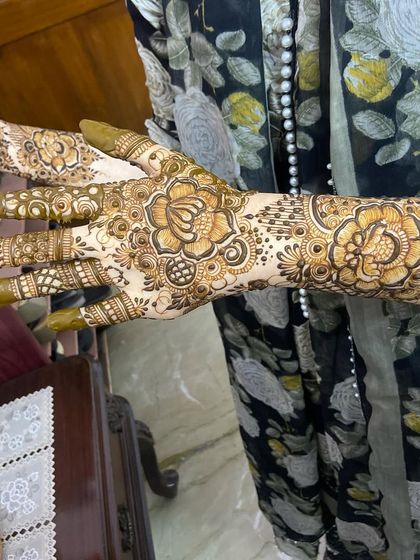 A beautiful floral design with filled fingertips, a classic choice for any celebration.