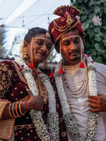 This candid shot from a Maharashtrian wedding captures the beautiful, unscripted moments between the couple. We believe these quiet, happy exchanges are just as important as the main rituals, adding a layer of authenticity to your wedding story.