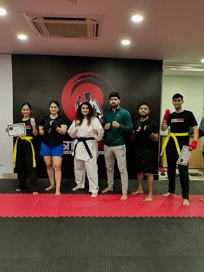 Students of different belt levels stand together, representing the journey of progress at our academy.
