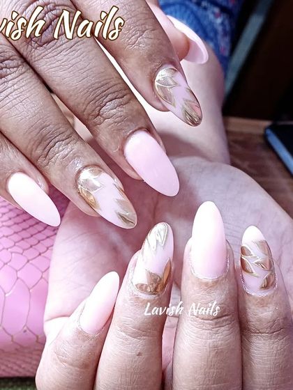 A soft pink set with accent nails featuring a beautiful gold leaf or foil design.
