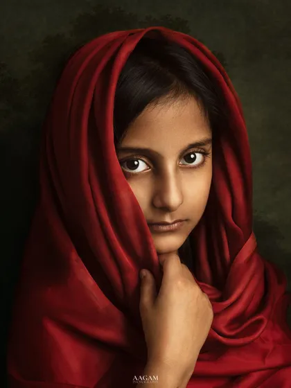 A powerful and evocative portrait, inspired by the famous "Afghan Girl." The red scarf and her intense gaze create a truly unforgettable image.