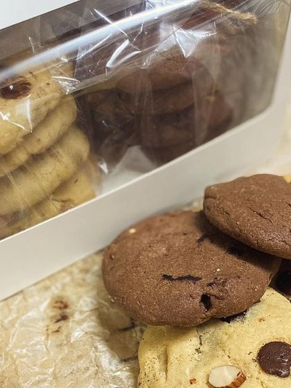 Our cookie gift box, featuring an assortment of classic and double chocolate chip cookies, all packed up and ready to be shared.