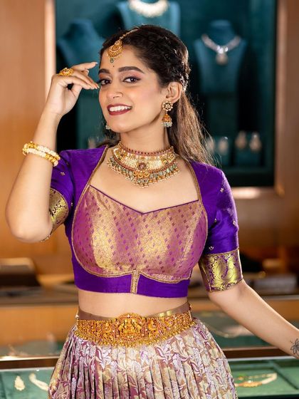 A joyful portrait of a model in a traditional half-saree. This look is perfect for pre-wedding ceremonies or for younger clients, showcasing versatility in bridal makeup.