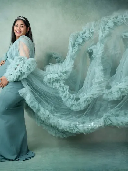 We love creating dynamic, breathtaking images. By tossing the fabric of this stunning ruffled gown, we add a sense of movement and magic to this maternity portrait.