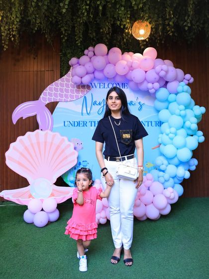 A mother and daughter hold hands at the entrance to the mermaid party. We create a welcoming and magical atmosphere from the moment you arrive.