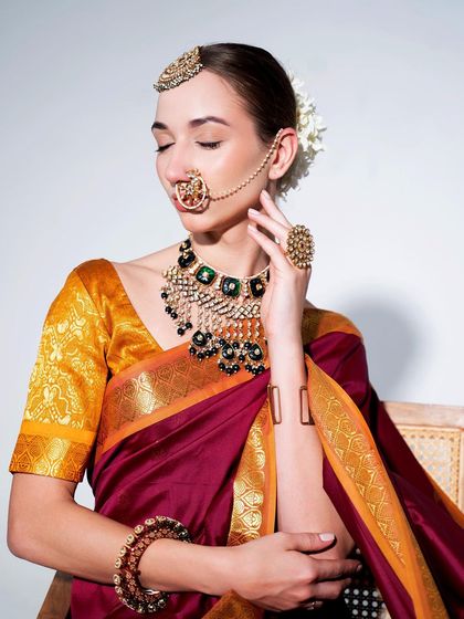 A timeless South Indian inspired look. A beautiful silk saree in maroon and gold, paired with a temple-style jewellery set.