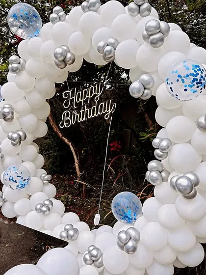 A close-up of the white and silver balloon ring, showing the mix of standard and confetti-filled balloons for added texture and fun.