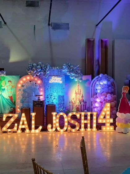 The party space viewed from the seating area, showing the impressive scale of the stage decoration.
