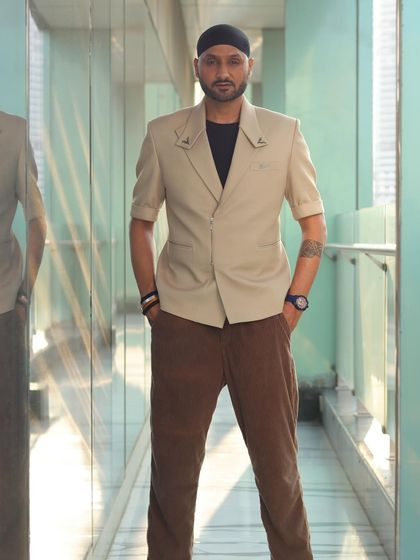 A straight-on shot of Harbhajan Singh in the beige short-sleeved blazer, highlighting its unique design.
