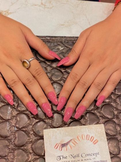 A lovely set of long, coffin-shaped nails in a shimmery dusty rose color. The subtle sparkle gives this classic color a modern update.