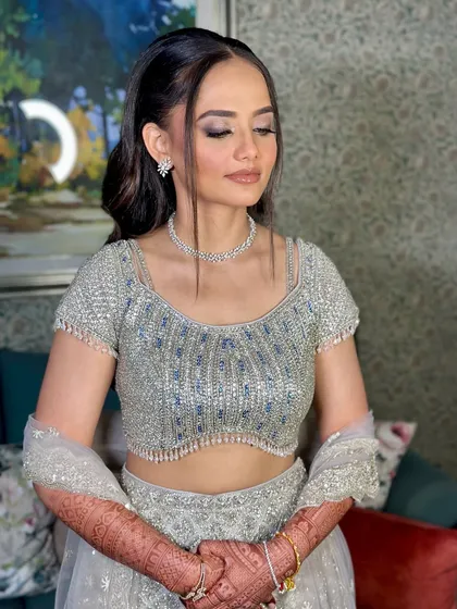 A serene shot of the bride. Her makeup looks flawless and radiant, ready for a night of celebration.