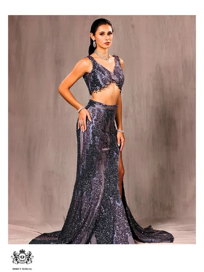 A full view of our shimmering co-ord set. The high-slit skirt and detailed crop top are designed to create a powerful silhouette, perfect for any celebration where you want to feel confident and bold.