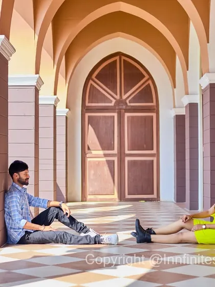 A casual, candid-style shot in a modern arched hallway, using natural light and symmetry to create a clean and contemporary pre-wedding photo.