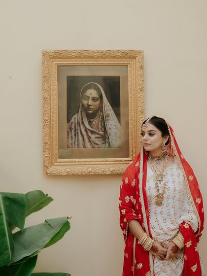 A series of portraits of a bride in a beautiful, traditional white and red saree, capturing her elegance, emotion, and moments with her family.