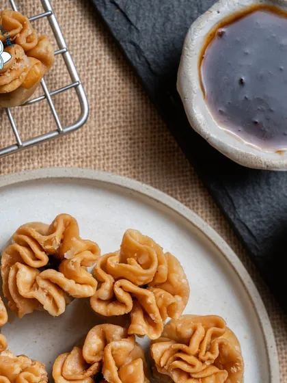A creative twist on a classic snack. These Potli Samosas are little bundles of joy, with a crispy, flaky exterior and a delicious, spiced filling. Their unique shape makes them a talking point at any event.