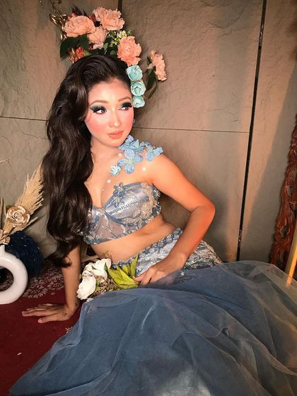 A full view of this whimsical, frosty look. The hair is styled in soft, flowing waves to complement the ethereal, fairy-like aesthetic.