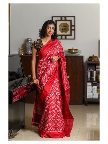 A full-length shot of the same red saree, providing a complete view of the outfit. This is essential for e-commerce listings and lookbooks, allowing customers to see the entire product.