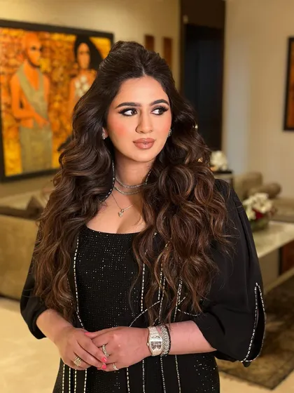 The client looking effortlessly cool and stylish with her beachy waves and half-bun.