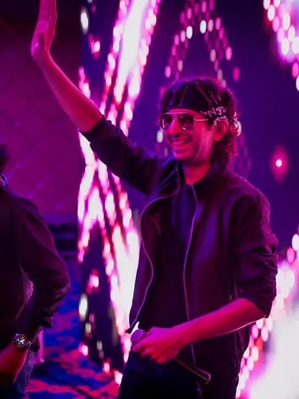 This is me in my element, mic in hand, connecting with the crowd. I'm not just behind the decks; I'm an entertainer, a mic maestro, making sure the energy on the dance floor is always at its peak.