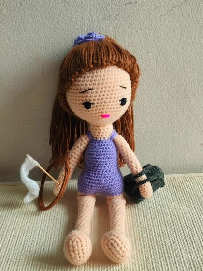 The gymnast doll sitting with her accessories. She is ready for her performance.