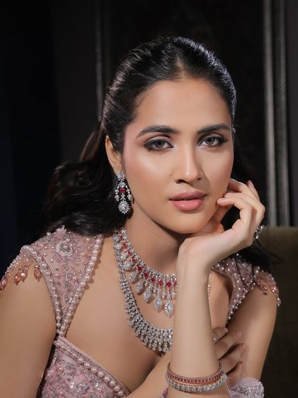 A thoughtful pose that showcases the beautiful contour and highlight. The makeup is designed to sculpt the face and create a luminous glow from every angle.