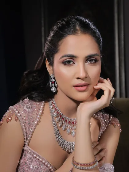 A thoughtful pose that showcases the beautiful contour and highlight. The makeup is designed to sculpt the face and create a luminous glow from every angle.