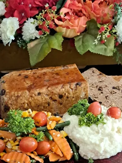 My Festive Meatloaf is a true Christmas special. I make it with chicken mince, bacon, cranberries, and pistachios for a dish that is both comforting and celebratory, served with creamy mashed potatoes and garden vegetables.