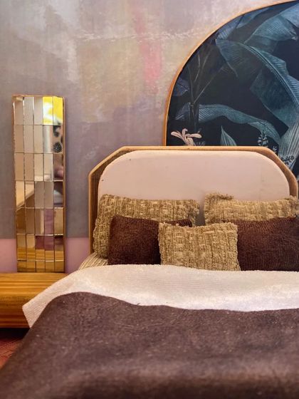 A close-up of the headboard and side table in the bedroom model. Tiny details, like the mirrored tiles and textured pillows, make the design feel real.