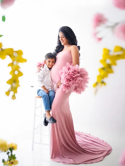 Can't handle the cuteness. A mamma and her son sharing a sweet moment during her maternity shoot. The matching pink and white outfits are so lovely.