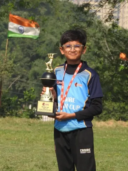 The joy of achievement. A young player from the Croire Youth Cup with his well-earned trophy.