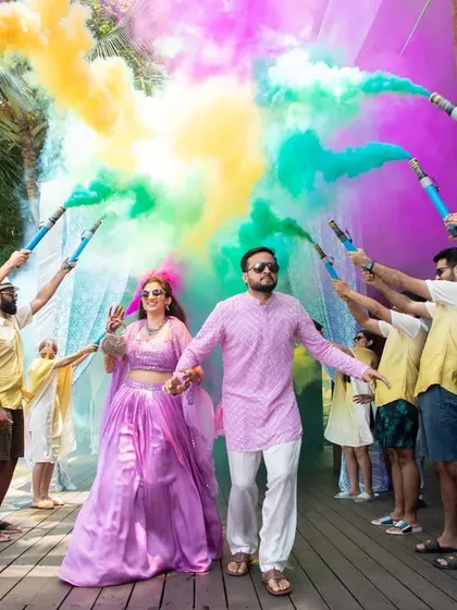 The perfect shot of a smoke bomb entry. We help you plan and execute creative ideas like this to ensure your wedding photos and videos are absolutely spectacular.