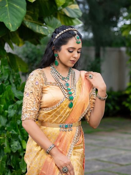 This look from my 'Athiloka Sundari' series features me in a pure Kanchi saree. I paired it with a blouse adorned with intricate embroidery and semi-precious stone embellishments, creating a regal outfit designed to make any bride feel like a princess.
