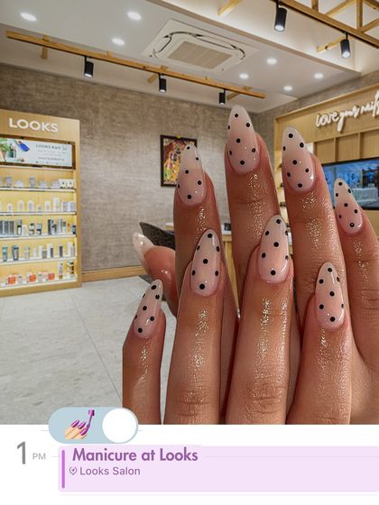 A fun and classic polka dot design on long, almond-shaped nails. This playful manicure is a great way to add a touch of personality to your look, all while enjoying the relaxing atmosphere of my salon.