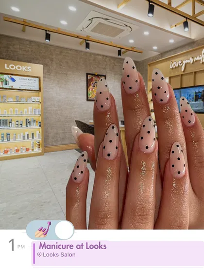 A fun and classic polka dot design on long, almond-shaped nails. This playful manicure is a great way to add a touch of personality to your look, all while enjoying the relaxing atmosphere of my salon.