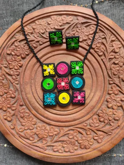 A customized necklace set I made for a client, featuring a colorful grid of embroidered fabric patches with mirror work. This is a great example of how we can create a unique piece based on your ideas.