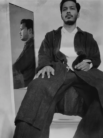 A moody, black and white portrait of blues artist Sameer Rahat, using a mirror to create a sense of reflection and introspection.