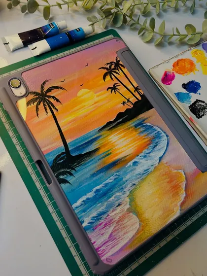 I love bringing dreamy beach sunsets to life on my custom iPad covers. This piece captures the warm glow of the sun and the texture of the waves using vibrant acrylic paints. The artwork is painted on a custom-fit insert, ensuring it stays protected and beautiful.