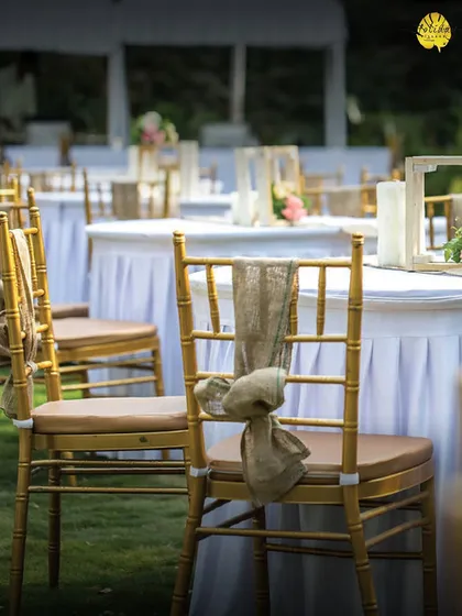 A closer look at the rustic-chic decor, with simple floral centerpieces and burlap chair ties, perfect for a daytime garden party or wedding lunch.