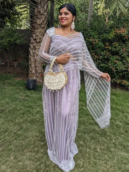 This straight-fit pearl lehenga saree is a perfect, lightweight choice for a daytime wedding. It combines the elegance of a saree with the comfort of a lehenga.