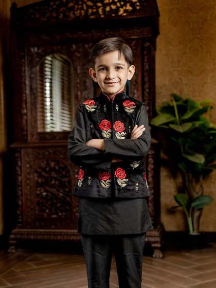 A full-length view of our black velvet Bundi with red rose embroidery. The complete outfit is a perfect balance of classic elegance and modern boldness.