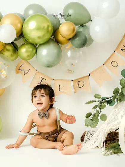 Welcome to the wild one's celebration. This jungle-themed first birthday setup with a custom banner and balloon arch creates a fun, adventurous atmosphere.