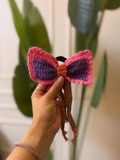 A multi-colored version of our crochet tassel bow. We love playing with color combinations to create unique pieces.