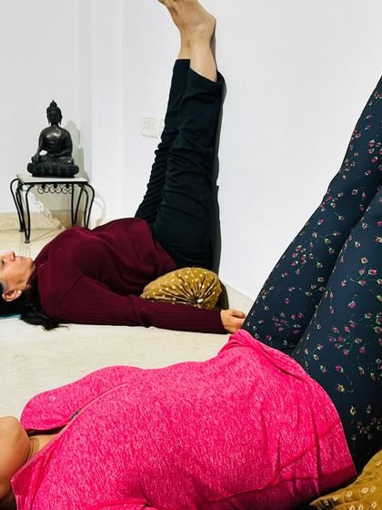 Viparita Karani, or Legs-Up-the-Wall Pose, is one of the most restorative postures in yoga. Here, students use cushions for support to help calm the nervous system, relieve tired legs, and promote deep relaxation.